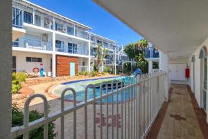 a view of the pool from the balcony of a apartment at Beachside Garden Apt Beach Scarborough with Parking in Perth