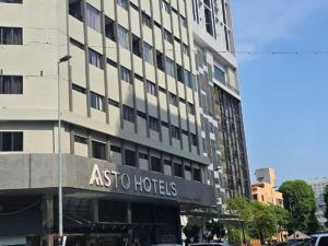 a building with an aso hotels sign in front of it at Asto Hotel Kuala Lumpur in Kuala Lumpur