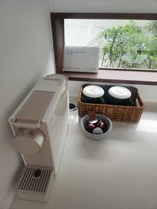 a bathroom with a toilet and a window with a basket at Andong Hanok Stay Hue in Andong +19 photos
