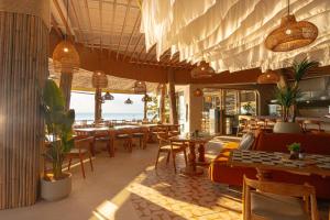 a restaurant with tables and chairs and a view of the ocean at Al's Resort in Chaweng