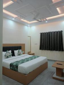 a bedroom with a large bed in a room at HOTEL SHIVAAY near by urban Square mall and nexus celebration mall in Bedla
