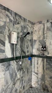 a bathroom with a shower with a shower head at Liina House in Ko Yao Noi +10 photos