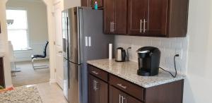 a kitchen with a refrigerator and a counter top at Home at Tucker in Tucker