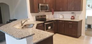 a kitchen with a sink and a stove top oven at Home at Tucker in Tucker +7 photos