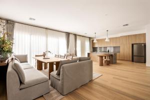 a living room with a table and chairs and a kitchen at Shining House Villa B in Tanunda