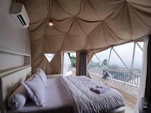 a bedroom with a bed in a tent at Anemos Resort By Tamastu in Pasirpogor +53 photos