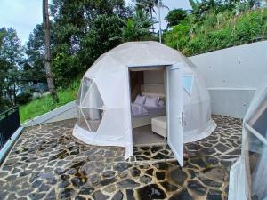 a bed in a tent on a patio at Anemos Resort By Tamastu in Pasirpogor
