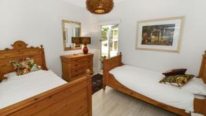 a bedroom with two beds and a mirror at Mackaren's Lodge - Chic in Macmasters Beach +7 photos