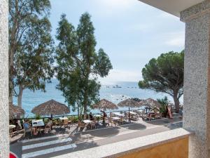 a view of the beach from the balcony of a resort at Hotel Ristorante La Conchiglia in Cala Gonone