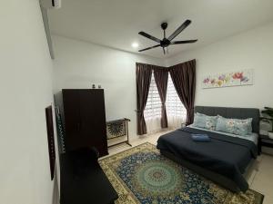 a bedroom with a bed and a ceiling fan at Hasna Homestay Cherating Muslimonly in Kuantan