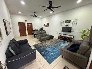 a living room with two couches and a table at Hasna Homestay Cherating Muslimonly in Kuantan