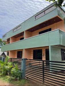 a building with a fence in front of it at Two-Storey Townhouse in Laguindingan