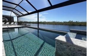 a swimming pool with a view of the water at Sandi Villa in Cape Coral