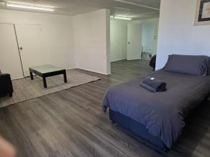 a room with a bed and a table in it at Tranquility Studio Two in Mission Beach