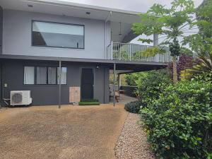 a house with a balcony and a walkway at Tranquility Studio Two in Mission Beach