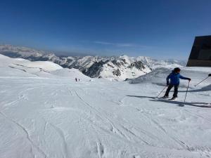 a person is skiing down a snow covered mountain at Moonriver Alps Ski Apartament in Ramingstein +14 photos
