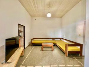 a room with two beds and a table in it at Casa del lago in Embalse