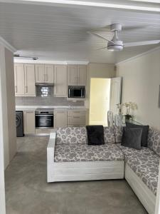 a living room with a couch and a kitchen at Seascape in Dwarskersbos