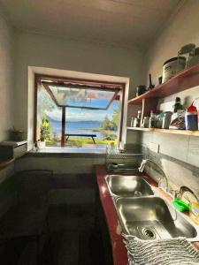 a kitchen with a sink and a window at Casa del lago in Embalse