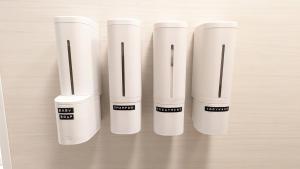 a group of four white kettles on a table at MyBound Homestay Zushi in Zushi +9 photos