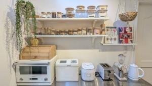 a kitchen with a counter with appliances on it at MyBound Homestay Zushi in Zushi