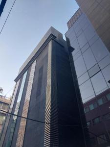a tall building with a lot of windows at GaGa Hotel dongdaemun in Seoul