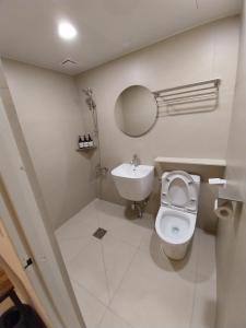 a white bathroom with a toilet and a sink at GaGa Hotel dongdaemun in Seoul