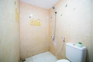 a bathroom with a shower with a toilet at Behomy Yume Grogol in Jakarta