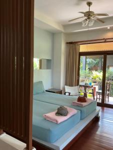 a bedroom with two beds with towels on them at Ananas Samui Hostel in Laem Set Beach +163 photos