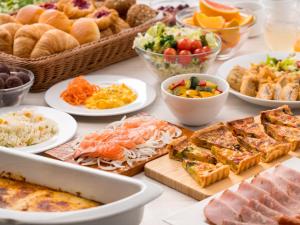 a table topped with lots of different types of food at Villa Fontaine Grand Tokyo Tamachi in Tokyo