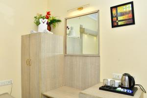 a bathroom with a shower with a mirror on the wall at The Rass in Kānpur +42 photos