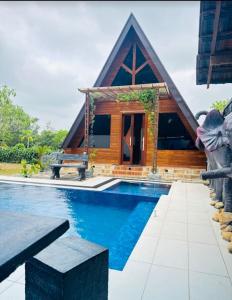 a resort with a pool and a house at Senu Lee Cabana in Galle