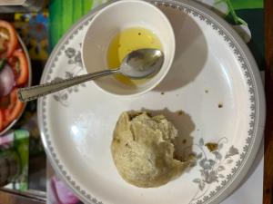 a bowl of peanut butter and a spoon on a plate at Ridhi Sidhi cottage in Kīar +6 photos