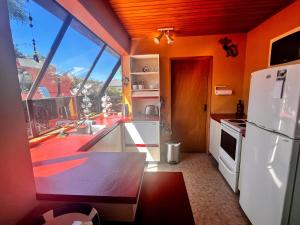 a kitchen with a white refrigerator and a large window at Cosy Corner Te Anau in Te Anau +5 photos