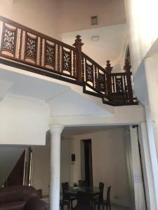 a staircase with a table and chairs in a room at oak yard in Nikawatawana