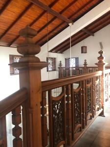 a wooden railing in a room with wooden ceilings at oak yard in Nikawatawana