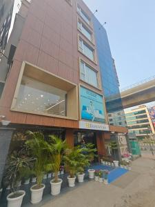 a building with palm trees in front of it at Hotel Teesta Stay, Kolkata in kolkata