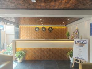 a lobby with two clocks on a wall at Hotel Teesta Stay, Kolkata in kolkata