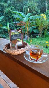 a book and a cup of tea on a table at Slow Home in Ban Yang Mae Luang