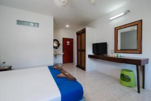 a bedroom with a bed and a mirror and a tv at C4 Resort in Ko Tao