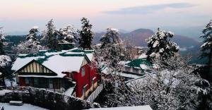 a red building with snow on top of it at The Boho BNB in Shimla +20 photos