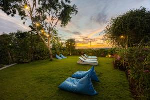 a yard with some blue inflatables on the grass at Cove Jiwana Villa in Nusa Dua