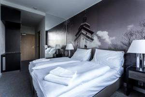 Postel nebo postele na pokoji v ubytování Hotel Bílý Páv