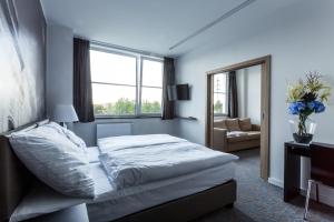 A bed or beds in a room at Hotel Bílý Páv