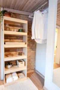 a closet with wooden shelves in a room at Rabygatan cottage in Old Limhamn in Malmö