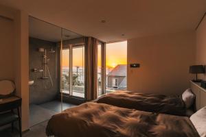 a bedroom with two beds and a large window at Château Marine by SUNGA in KAMAKURA in Kamakura
