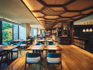 a restaurant with wooden floors and tables and chairs at Hotel Indigo Hakone Gora by IHG in Hakone