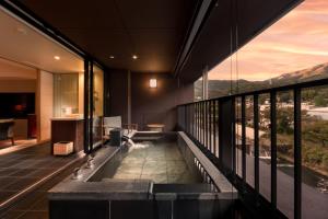 a bathtub in the middle of a room at Hotel Indigo Hakone Gora by IHG in Hakone