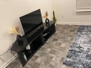 a flat screen tv on a stand in a living room at Inner Haven Family Homes in Indianapolis