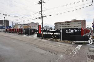 a train is parked next to a fence at HOTEL R9 The Yard Uozu in Motoshin +16 photos